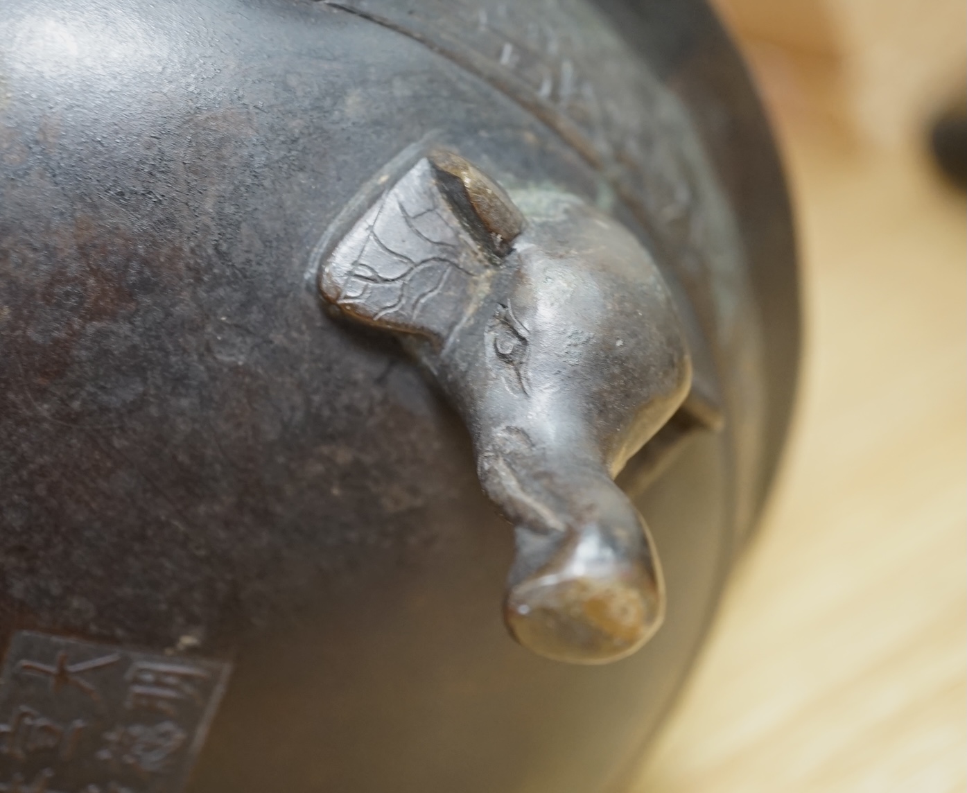 A Chinese archaistic bronze tripod ‘elephant head’ censer, Xuande mark, 19th century, 24cm handle to handle. Condition - fair to good